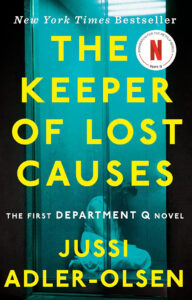 Book cover for “The Keeper of Lost Causes” by Jussi Adler-Olsen, showing a person sitting in a cell.
