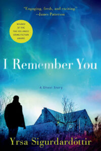 Blue book cover with a silhouette, a house, trees, and text: “I Remember You, Yrsa Sigurdardottir.”.