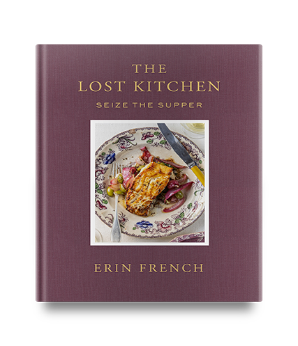 A cookbook titled “The Lost Kitchen” by Erin French with a plate of food on the cover.