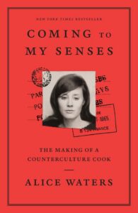 Red book cover for “Coming to My Senses” by Alice Waters with a black-and-white photo of a woman.