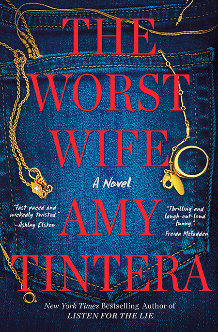 A gold necklace and ring on blue jeans with the book title “The Worst Wife” by Amy Tintera in red text.
