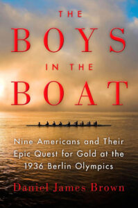 Book cover for The Boys in the Boat by Daniel James Brown, featuring a rowing crew on water at sunrise.